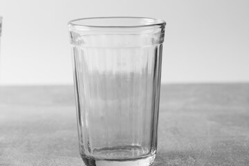 Empty glass on gray background. Closeup.