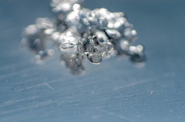 Liquid Metal Macro on Blue Surface