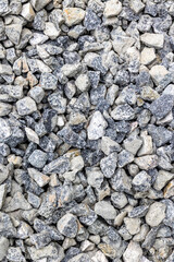 Rough gray and white gravel stones texture with mixed sizes