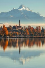 Obraz premium Serene mountain lake reflection with colorful autumn trees and distant, snow-capped peak.,