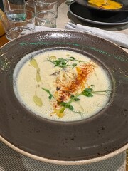 Cream cheese or mushroom soup in a cafe. Vertical
