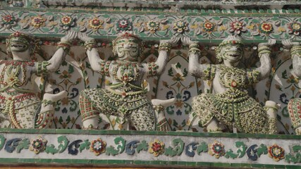 The yaksha statues in the details of the main pagoda of Wat Arun a famous Buddhist temple located on the banks of the Chao Phraya River in Bangkok, Thailand.
