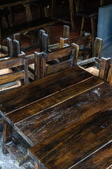 Rustic wooden furniture set in dimly lit room with sturdy design