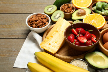 Different products rich in dopamine on wooden table