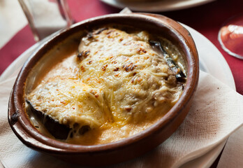 Appetizing baked eggplants stuffed with meat in bechamel sauce sprinkled with grated cheese. Traditional dish of Spanish cuisine ..