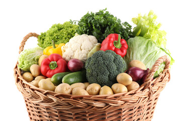 Different fresh vegetables in wicker basket isolated on white