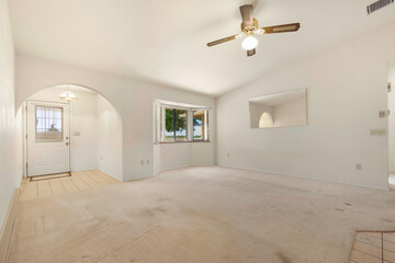 Spacious living room with wooden flooring and sliding doors leading to a bright outdoor area