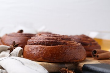 Delicious cinnamon roll buns on table, closeup