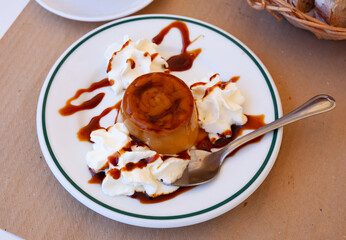 Sweet spanish dessert cream flan with butter cream served at plate, nobody