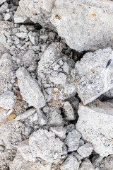 Close-up of cracked concrete surface with rough texture and mixed aggregate