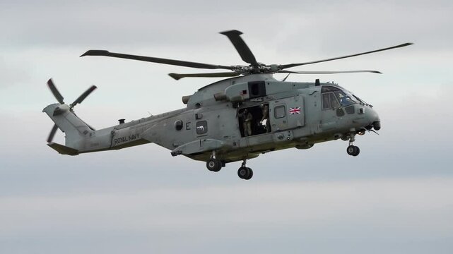 British Royal Navy Agusta-Westland Merlin HM.2 AW101 helicopter hovering on a military exercise, Wiltshire UK