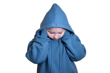 Girl dressed in blue hoodie lowers head down and covers ears with hands on transparent background. Concept of kidnapping, fear, fright and loneliness