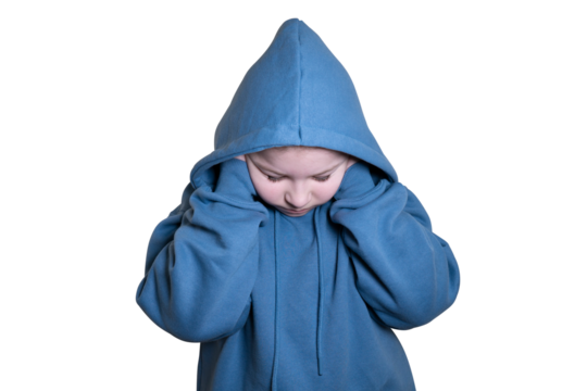Girl dressed in blue hoodie lowers head down and covers ears with hands on transparent background. Concept of kidnapping, fear, fright and loneliness