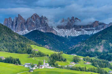 Panorama of Santa Maddalena village and church in the Dolomites, Puez Odle national park in Italy. Italian Dolomiti Alps scenic landscape in summer with beautiful sunlight at sunset