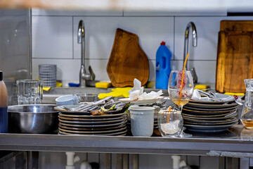 A kitchen counter with a bunch of plates and glasses on it