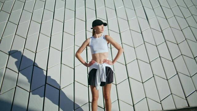 Woman runner start training at sunny street wearing sportswear. Lady running