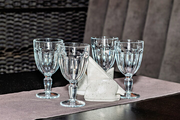 Three empty wine glasses sitting on top of a table