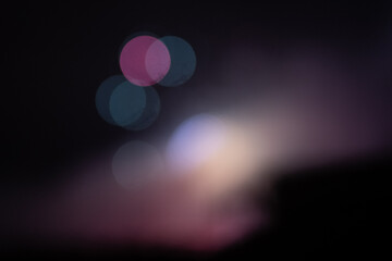 Blurry lights spotlights on a dark scene abstract background