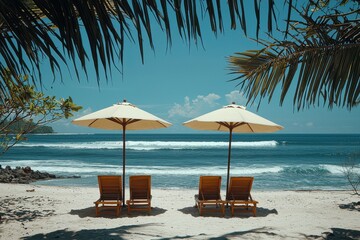 Obraz premium Serene beach setting with two chairs under umbrella on sandy shore
