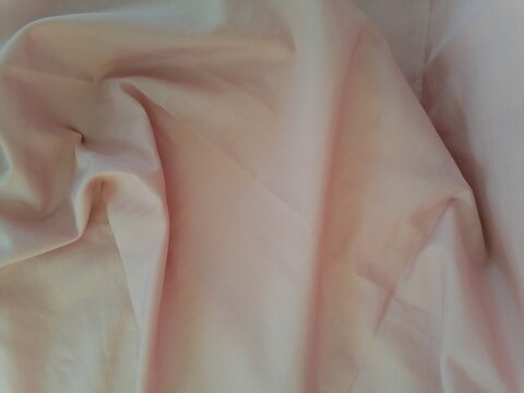 Silk Texture Unveiled Crumpled Light Pink Fabric Close-Up