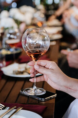 Hand holding elegant wine glass, perfect for celebrations, dining, and social gatherings