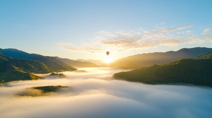 Fototapeta premium A lone hot air balloon floating over a valley at sunrise. Hot air balloon photographed by a drone in ethereal landscape.