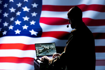 US military officer using target acquisition technology to detect location of enemies hiding....