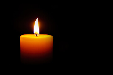 Yellow Candle Light Burn Against Black Background