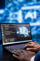 System administrator analyzing complex AI brain models on laptop. Close up shot of worker using...