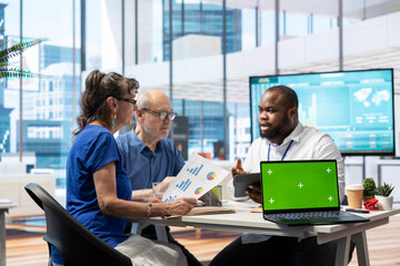 Elderly people meeting with a financial expert next to chroma key display, exploring various retirement options and ensuring their savings for the future. Investment strategy advice.