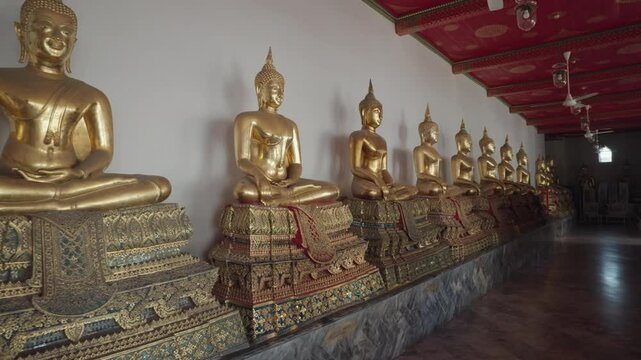 Bangkok, Thailand - A row of golden Buddha statues in the Wat Pho complex. Wat Pho is one of Bangkok's oldest temples.
