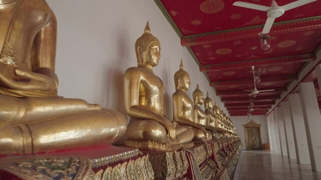 Bangkok, Thailand - A row of golden Buddha statues in the Wat Pho complex. Wat Pho is one of Bangkok's oldest temples.