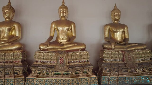 Bangkok, Thailand - A row of golden Buddha statues in the Wat Pho complex. Wat Pho is one of Bangkok's oldest temples.
