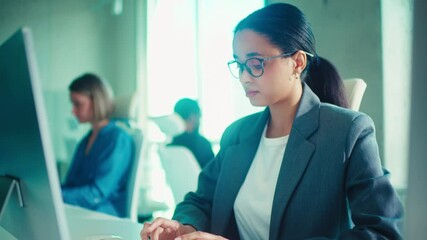 Professional Woman Typing in a Modern Office Setting