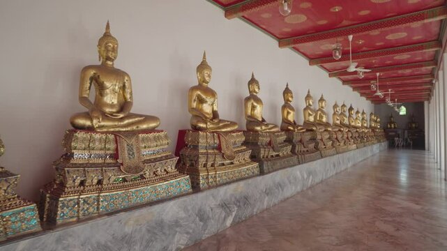 Bangkok, Thailand - A row of golden Buddha statues in the Wat Pho complex. Wat Pho is one of Bangkok's oldest temples.