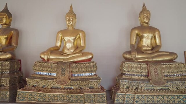 Bangkok, Thailand - A row of golden Buddha statues in the Wat Pho complex. Wat Pho is one of Bangkok's oldest temples.