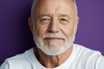 Obraz premium Elderly man with a warm smile against a purple backdrop embodies confidence and wisdom in a serene moment of reflection