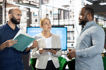 Team leader and employees developing and implementing business strategies to improve operational efficiency and profitability. Company supervisor setting key revenue performance targets for workers