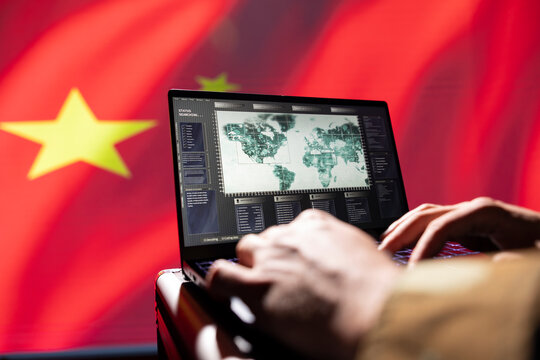Chinese red army operative engaged in surveillance mission using laptop, looking at aerial map of conflict zone. Intelligence officer working for CCP government monitoring zone of interest