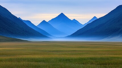 Fototapeta premium Valley meadow and expansive, A tranquil landscape featuring distant blue mountains, rolling hills, and a misty valley, creating a serene atmosphere.