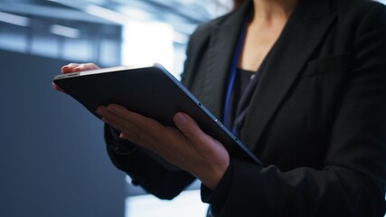 Programmer managing data center with advanced technology using digital device. Close up shot of...