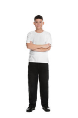 Full length portrait of teenage boy with crossed arms on white background