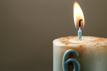Celebrating a child's sixth birthday with a lit candle and colorful cake decoration
