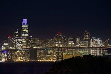 Obraz premium The skyline of San Francisco glows over the cold, dark San Francisco Bay