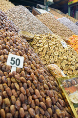 Dates, apricots, almonds and snacks displayed in business of Marrakech square