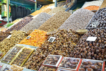 Dates, apricots, almonds and snacks displayed in business of Marrakech square