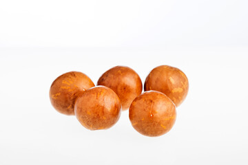Organic macadamia nuts isolated on white background - Macadamia integrifolia.