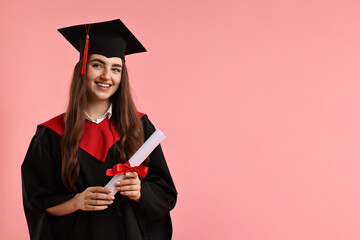 Happy student with diploma after graduation on pink background. Space for text