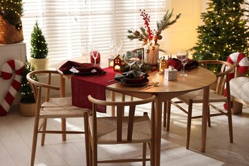 Christmas table setting with stylish dishware and festive decor indoors