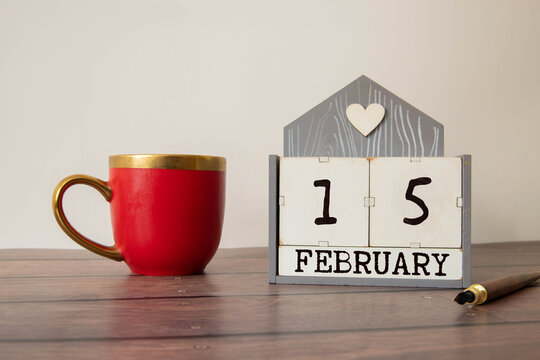 Cube shape calendar for february 15 on wooden calendar.